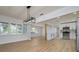 Open concept dining area with modern light fixture and wood flooring at 8462 8Th N Way, St Petersburg, FL 33702