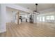 Open concept dining area with modern light fixture and wood flooring at 8462 8Th N Way, St Petersburg, FL 33702