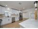 Modern kitchen with white cabinets, quartz countertops, and stainless steel appliances at 8462 8Th N Way, St Petersburg, FL 33702