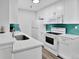 Modern kitchen with white cabinets and teal backsplash at 10265 Gandy N Blvd # 1507, St Petersburg, FL 33702