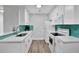 Modern kitchen with white cabinets and teal backsplash at 10265 Gandy N Blvd # 1507, St Petersburg, FL 33702