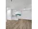 Bright living room with wood-look floors and kitchen at 10265 Gandy N Blvd # 1507, St Petersburg, FL 33702