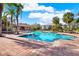 Community pool with surrounding patio and palm trees at 10265 Gandy N Blvd # 1507, St Petersburg, FL 33702