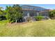 Landscaped backyard with a large screened patio at 10338 Highland Park Pl, Palmetto, FL 34221