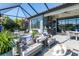 Screened patio with outdoor kitchen and lush landscaping at 10338 Highland Park Pl, Palmetto, FL 34221