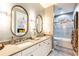 Elegant bathroom featuring a double vanity, bathtub, and shower at 10338 Highland Park Pl, Palmetto, FL 34221