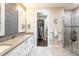Spa-like bathroom with walk-in shower and double vanity at 10338 Highland Park Pl, Palmetto, FL 34221