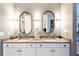 Modern bathroom with double vanity and oval mirrors at 10338 Highland Park Pl, Palmetto, FL 34221