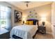 Guest bedroom with a queen bed, nightstands, and artwork at 10338 Highland Park Pl, Palmetto, FL 34221