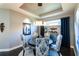 Elegant dining room with dark wood floors and blue patterned chairs at 10338 Highland Park Pl, Palmetto, FL 34221