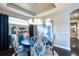 Elegant dining room with dark wood floors and blue patterned chairs at 10338 Highland Park Pl, Palmetto, FL 34221