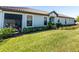 Single story home with teal door and well manicured lawn at 10338 Highland Park Pl, Palmetto, FL 34221