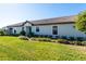 Single story home with teal door and well manicured lawn at 10338 Highland Park Pl, Palmetto, FL 34221