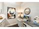 Home office with granite desk, comfortable seating, and large artwork at 10338 Highland Park Pl, Palmetto, FL 34221