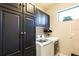 Laundry room with built-in cabinets and a sink at 10338 Highland Park Pl, Palmetto, FL 34221