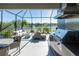 Outdoor kitchen with stainless steel appliances and lake view at 10338 Highland Park Pl, Palmetto, FL 34221
