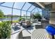 Covered outdoor kitchen and patio overlooking a lake at 10338 Highland Park Pl, Palmetto, FL 34221