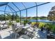 Screened patio with lake view and comfortable seating at 10338 Highland Park Pl, Palmetto, FL 34221