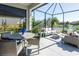 Relaxing screened-in patio with seating and lake view at 10338 Highland Park Pl, Palmetto, FL 34221