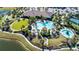 Expansive pool area with multiple pools, lounge areas, and palm trees at 10338 Highland Park Pl, Palmetto, FL 34221