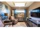 Cozy sitting room with comfortable armchairs and large TV at 10338 Highland Park Pl, Palmetto, FL 34221