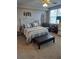 Bright bedroom featuring a queen-size bed and an adjoining sitting area at 1200 Country Club Dr # 1103, Largo, FL 33771