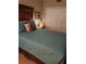 Cozy bedroom with antique wooden bed and teal bedding at 1200 Country Club Dr # 1103, Largo, FL 33771