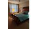 Charming bedroom with antique wooden bed and teal bedding at 1200 Country Club Dr # 1103, Largo, FL 33771