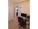 Home office with a desk, chair, and view of the kitchen at 1200 Country Club Dr # 1103, Largo, FL 33771