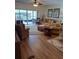 Living room with hardwood floors, comfy seating, and access to a balcony at 1200 Country Club Dr # 1103, Largo, FL 33771