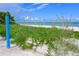 Oceanfront view with beach grass and blue post at 123 9Th St, Belleair Beach, FL 33786