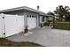 Newly painted teal home with white garage door and updated landscaping at 123 9Th St, Belleair Beach, FL 33786