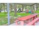 Red picnic table under a shaded pavilion, perfect for outdoor gatherings at 123 9Th St, Belleair Beach, FL 33786