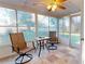 Bright sunroom with tiled floor, chairs, and game table at 14250 86Th Ter, Seminole, FL 33776