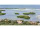 Wide shot of waterfront homes and tropical landscape at 1571 Oceanview Dr, St Petersburg, FL 33715
