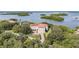 Aerial view of home on waterfront property with lush landscaping and boat access at 1571 Oceanview Dr, St Petersburg, FL 33715