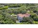 Aerial view showing home nestled in a wooded area with a fountain and pool at 1571 Oceanview Dr, St Petersburg, FL 33715