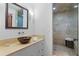 Bathroom with copper bowl sink and walk-in shower at 1571 Oceanview Dr, St Petersburg, FL 33715