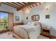 Bedroom with hardwood floors, wood beams, and a view at 1571 Oceanview Dr, St Petersburg, FL 33715