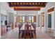 Spacious dining room with large windows and a long wooden table at 1571 Oceanview Dr, St Petersburg, FL 33715