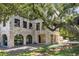 Stone house with a pool and large oak tree at 1571 Oceanview Dr, St Petersburg, FL 33715