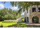 Stone house exterior with circular pool and landscaping at 1571 Oceanview Dr, St Petersburg, FL 33715