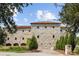 Stone exterior of a two-story home with a tile roof and lush landscaping at 1571 Oceanview Dr, St Petersburg, FL 33715