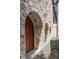 Arched wooden garage door with stone surround at 1571 Oceanview Dr, St Petersburg, FL 33715