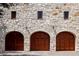 Three-car garage with arched wooden doors at 1571 Oceanview Dr, St Petersburg, FL 33715