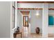 Hallway with high ceilings, exposed beams, and large windows showcasing nature views at 1571 Oceanview Dr, St Petersburg, FL 33715