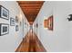 Long hallway with hardwood floors and wooden beams at 1571 Oceanview Dr, St Petersburg, FL 33715