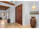 Elegant hallway with hardwood floors, a large wooden door and unique decor at 1571 Oceanview Dr, St Petersburg, FL 33715