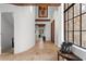 Long hallway with high ceilings, exposed beams, and unique artwork at 1571 Oceanview Dr, St Petersburg, FL 33715