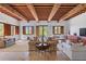 Spacious living room with high ceilings, exposed beams, and ample natural light at 1571 Oceanview Dr, St Petersburg, FL 33715